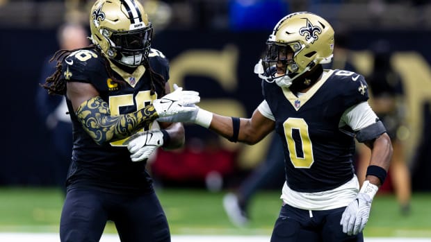 New Orleans Saints linebacker Demario Davis (56) and safety Ugo Amadi (0) celebrate after a play.